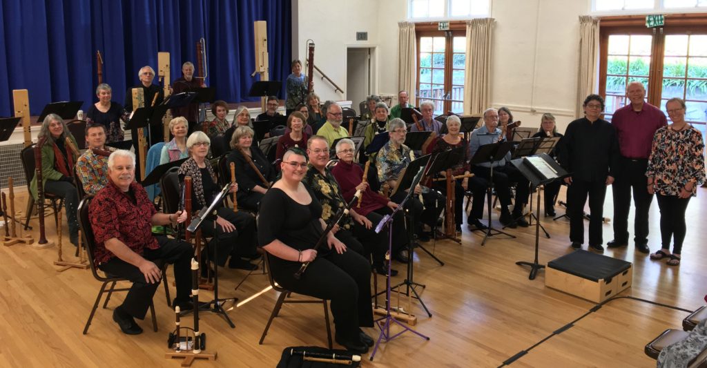 BCRO recorder players and conductors holding many different sizes of recorders at a rehearsal